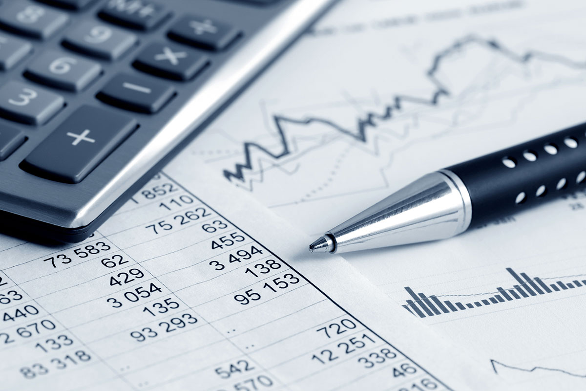 Corner of calculator with charts, graphs and a pen