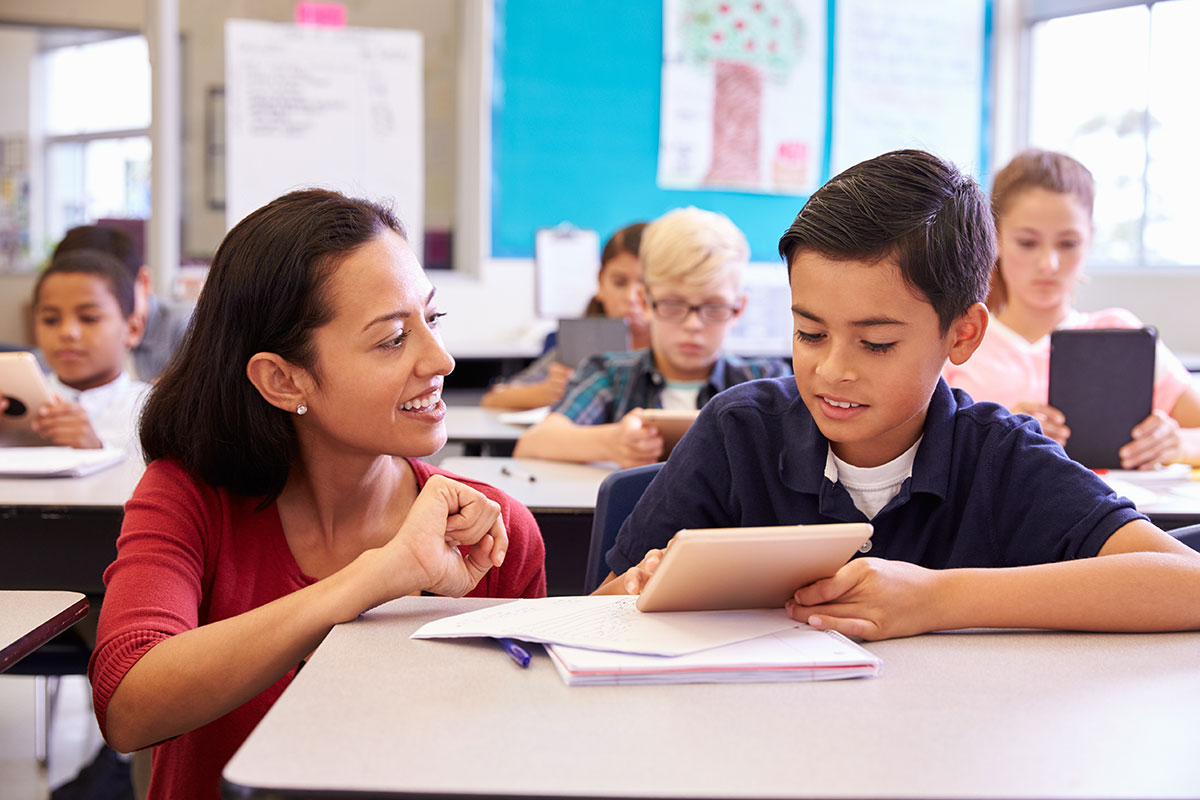 woman helping child with school work