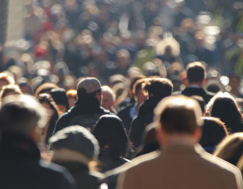Blurred faceless crowd
