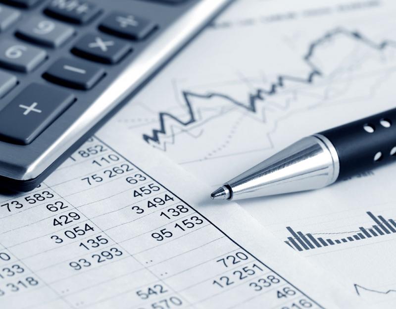 Corner of calculator with charts, graphs and a pen