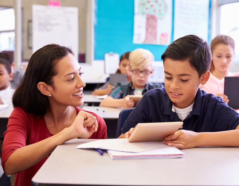 woman helping child with school work