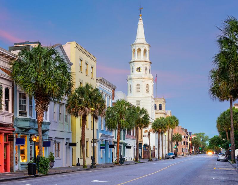 Street lined with colorful buildings and palm trees