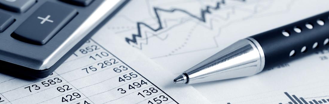 Corner of calculator with charts, graphs and a pen