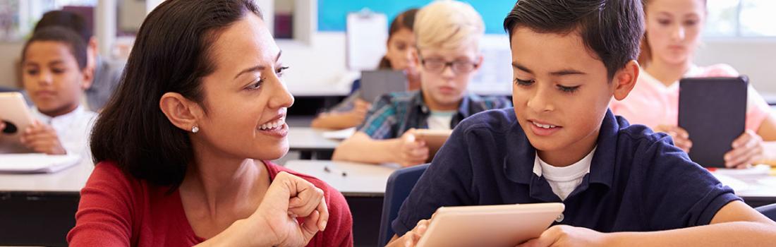 woman helping child with school work