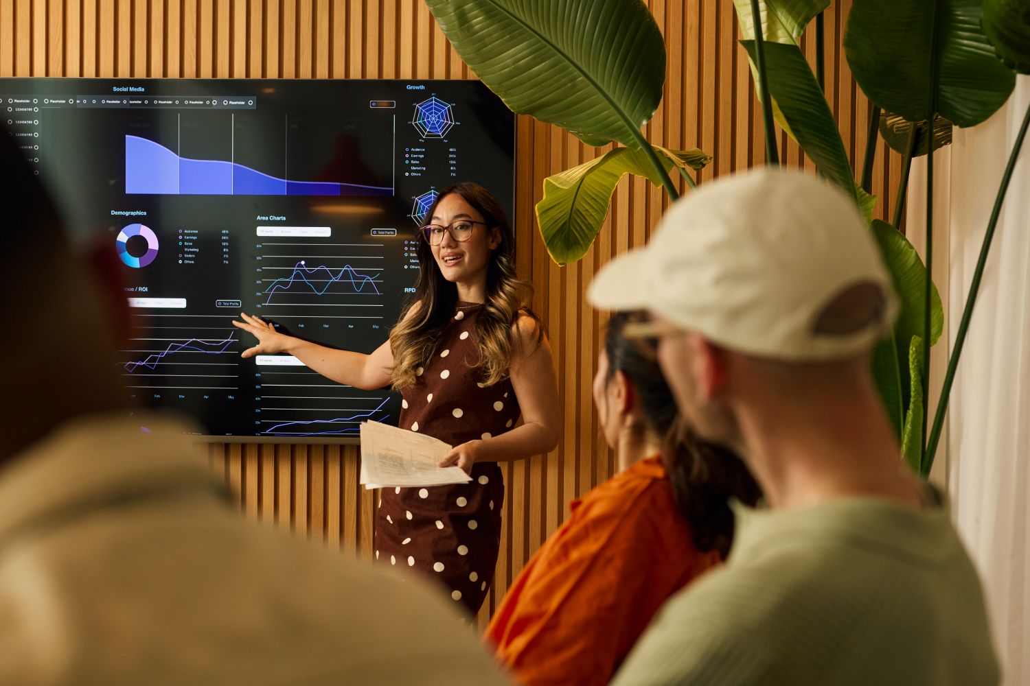 Speaker delivering a presentation in front of a smartboard image