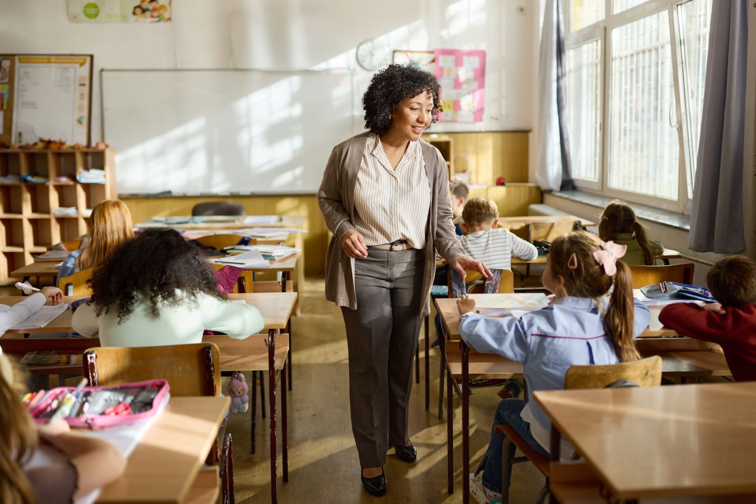 Teacher talking to students in a classroom image